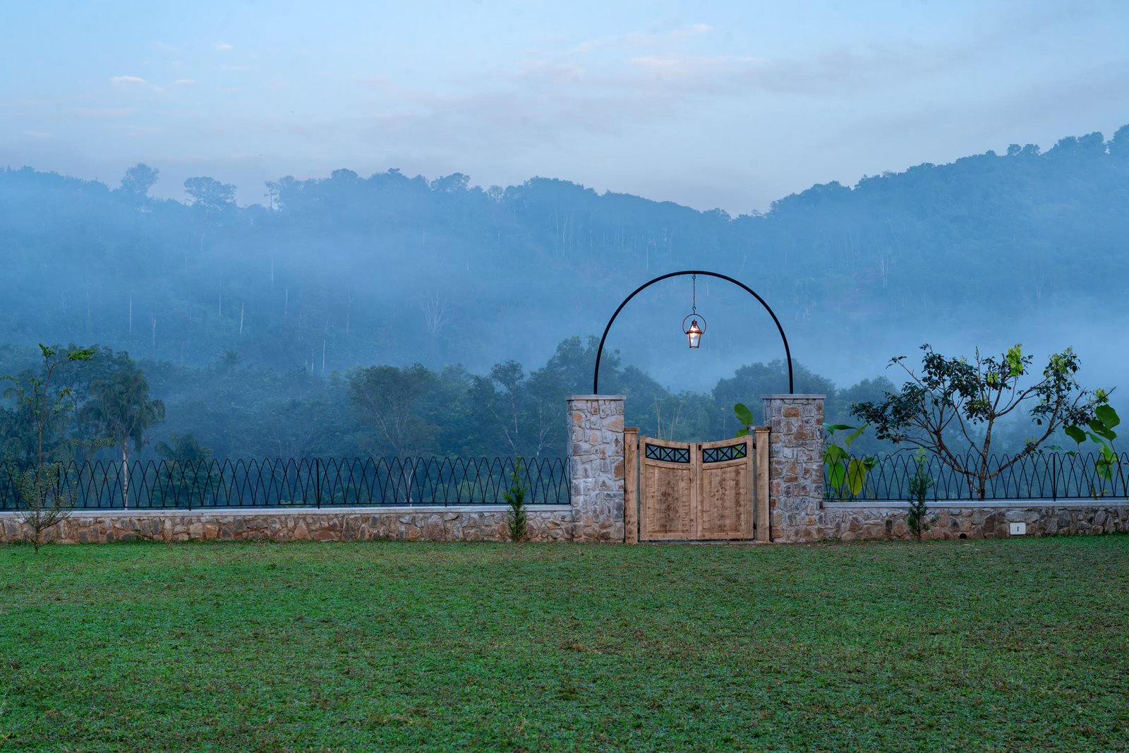 Entrance lawn overlooking layered green hills