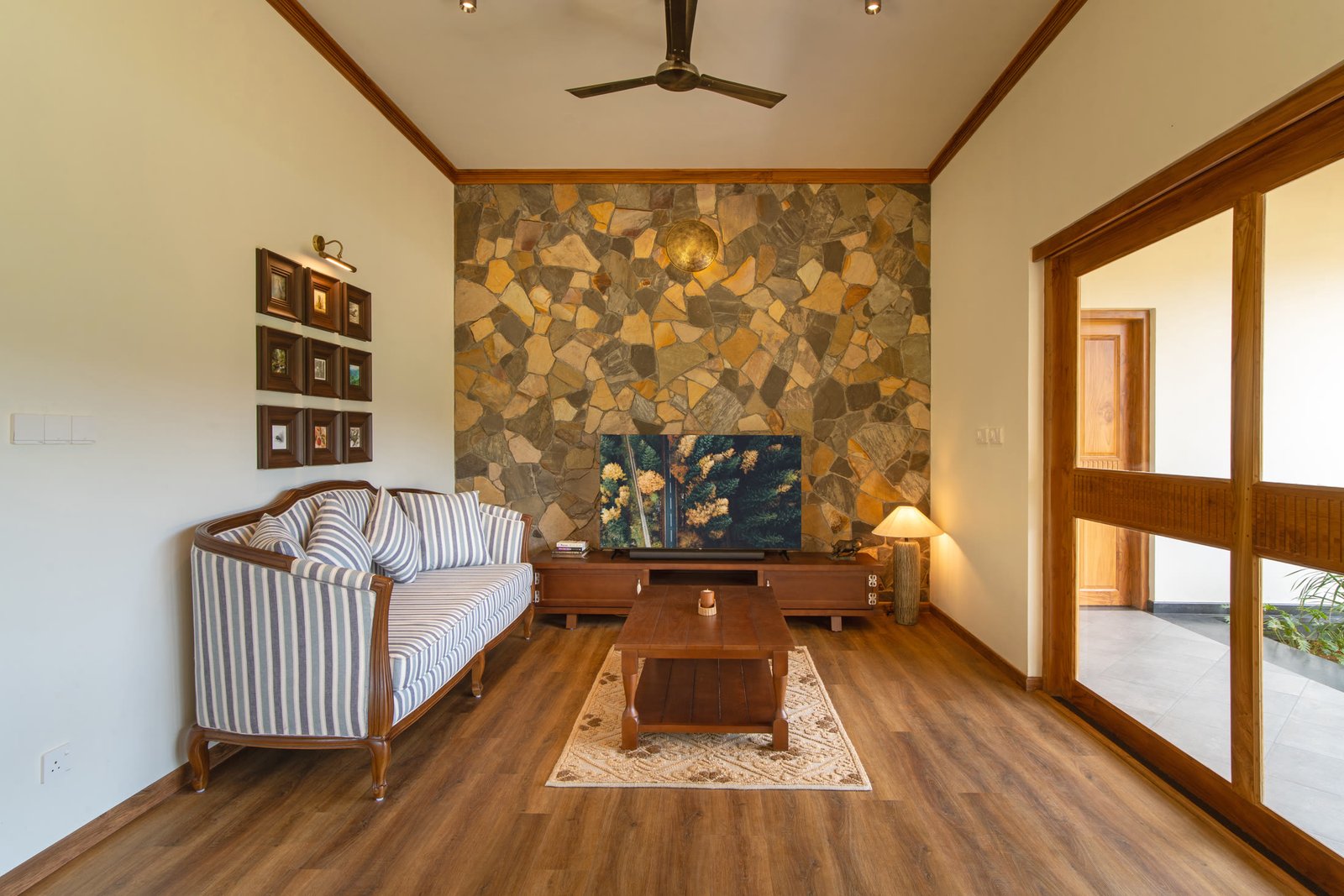 Living room with stone feature wall and garden views