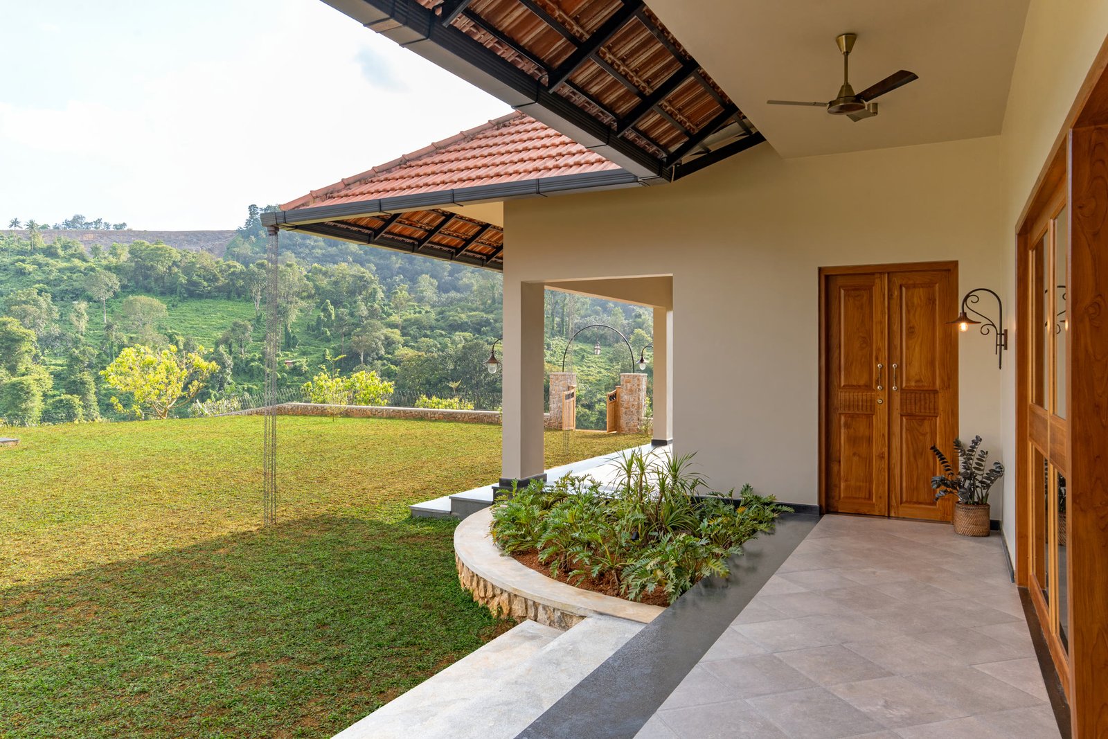 Covered courtyard walkway opening towards the lawn