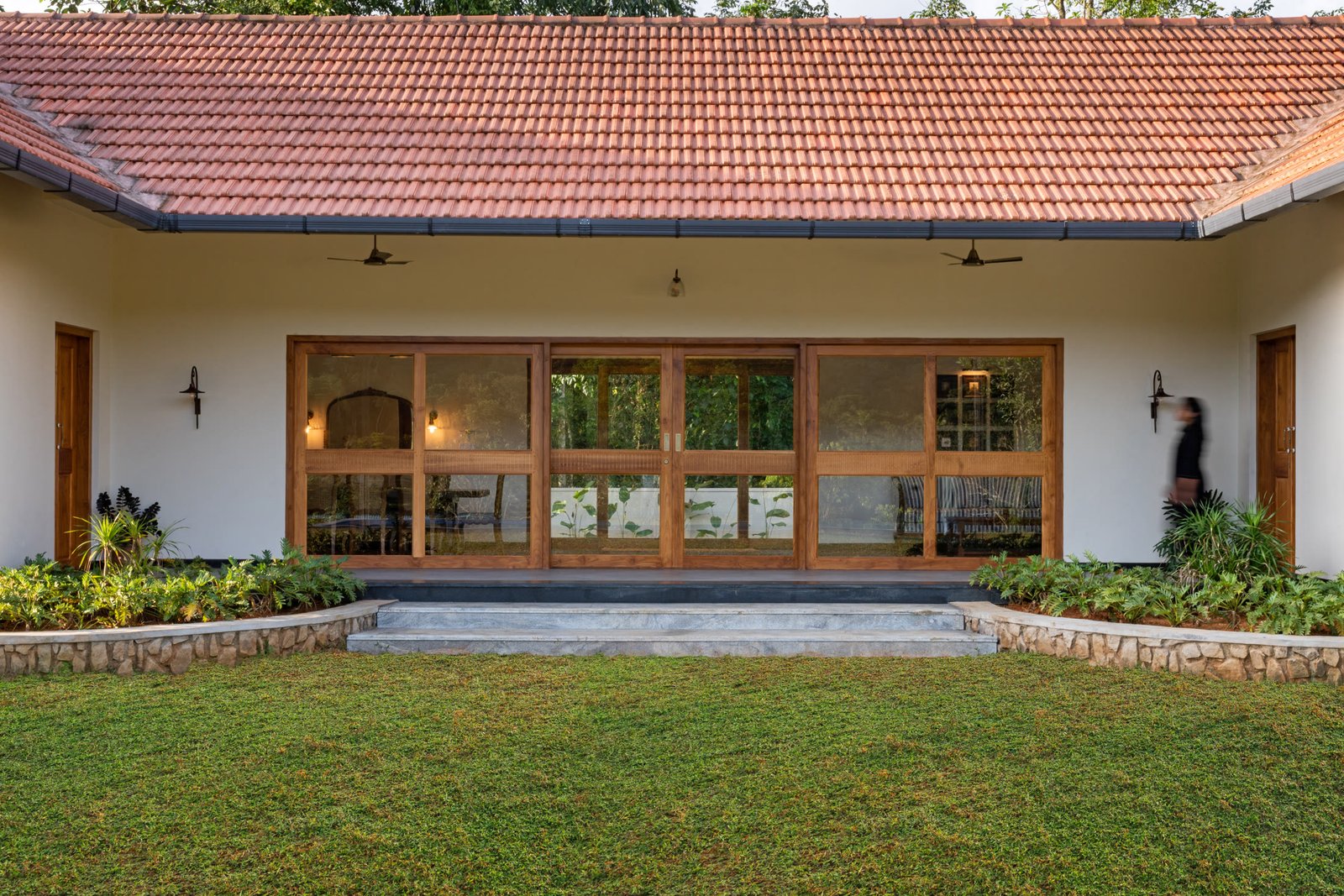 Courtyard facade framed by a tiled roof and lawn