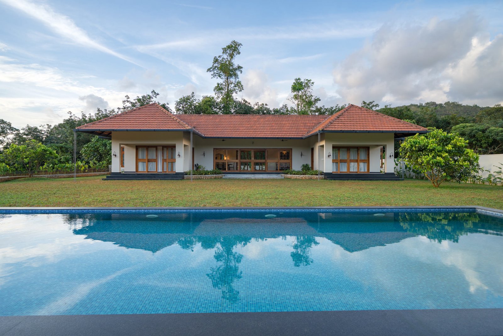 The private pool reflecting the farmhouse and green hills