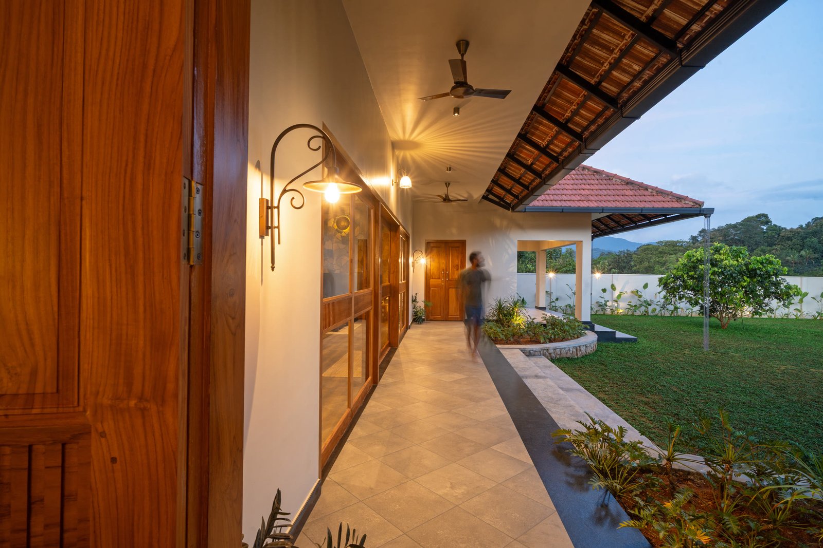 Warm lights along the covered courtyard at dusk